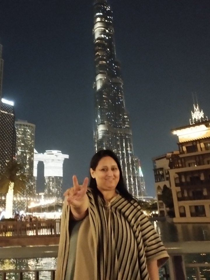 Tina Singh (1970–2026) in Downtown Dubai with the Burj Khalifa behind her